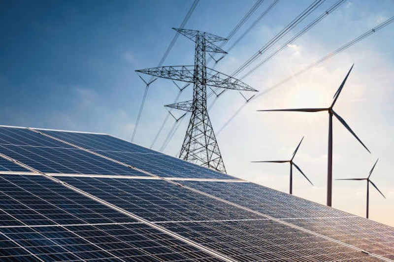 electricity power in nature. clean energy concept. solar panel with turbine and tower hight voltage